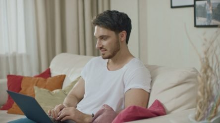 rsz_smiling-man-working-with-laptop-computer-at-home-sofa-young-man-chatting-online-on-lap-sbi-349448567