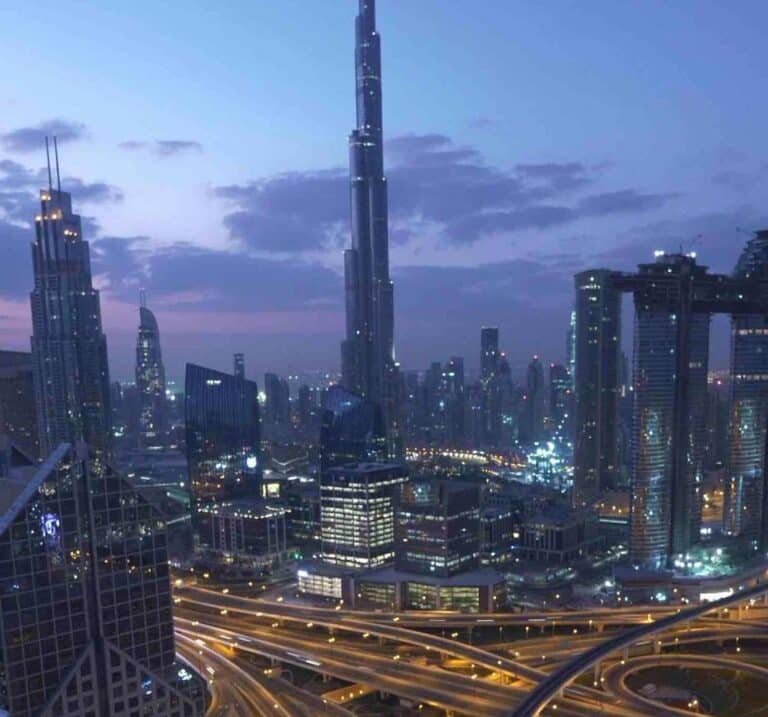 Hyper-realistic square image of Burj Khalifa rising at dawn over Dubai skyline, symbolizing expat burnout transformation and radical rise with Coach G's R.I.S.E.™ Method